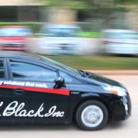 A R.K. Black service technician on the move in one of our two-dozen Toyota Prii.
